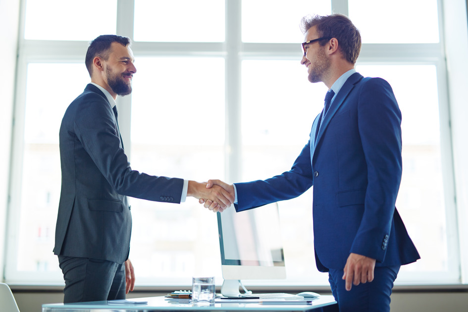 Two business men shaking hands.